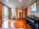 Spacious living room with hardwood floors and piano