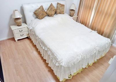 Cozy bedroom with elegant white bedding and wooden floor