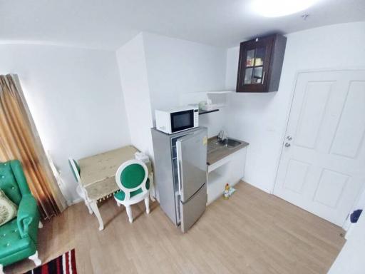 Compact kitchen with modern appliances and a small dining area