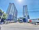 Modern twin residential towers with secured gate entrance