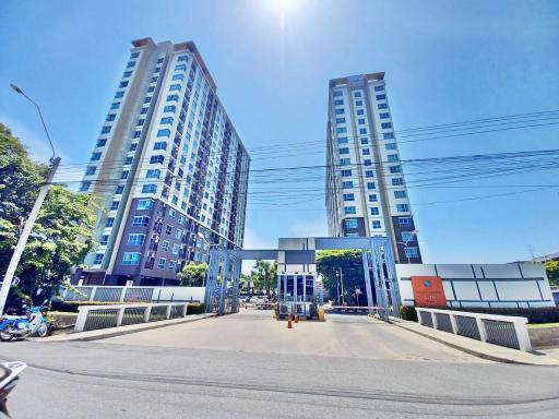 Modern twin residential towers with secured gate entrance