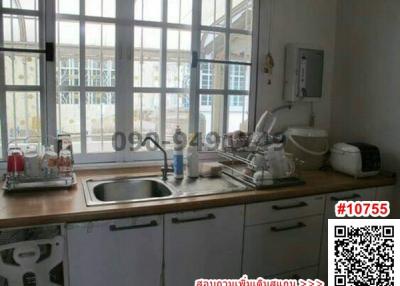 Compact kitchen with large window and modern appliances