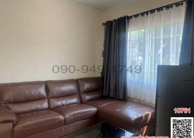 Cozy living room with brown leather sofa and natural light