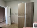 Spacious bedroom with wooden flooring and wardrobe