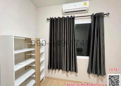 Compact bedroom with an air conditioner and built-in shelving unit