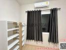 Compact bedroom with an air conditioner and built-in shelving unit