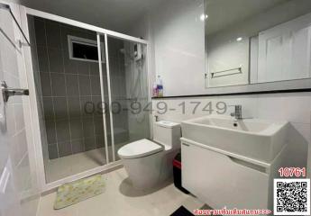 Modern bathroom with glass shower and white fixtures