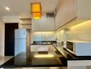 Modern kitchen with stainless steel appliances and LED lighting