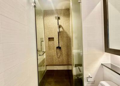 modern bathroom with walk-in shower and tiled walls