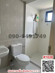 Compact tiled bathroom with modern fixtures and wall-mounted shower