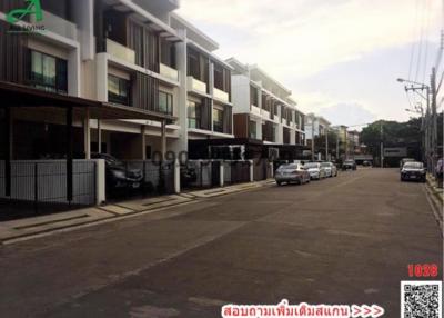 Exterior view of modern residential townhouses with parking spaces