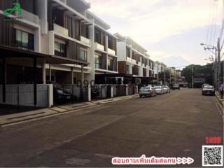 Exterior view of modern residential townhouses with parking spaces