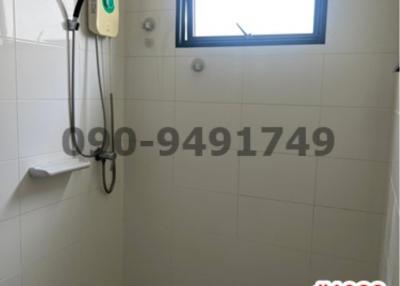 Bright bathroom with electric water heater and small window