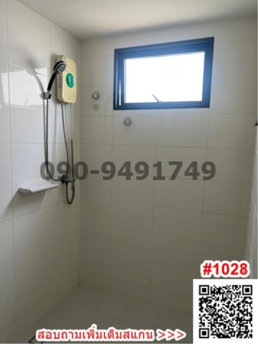 Bright bathroom with electric water heater and small window