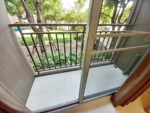 Cozy balcony with garden view and clear sliding glass doors