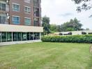 Exterior view of a modern apartment building with green lawn