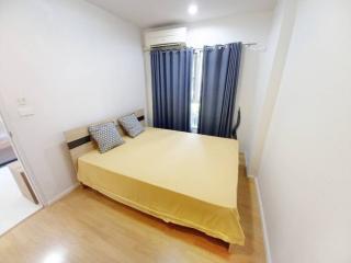 Cozy bedroom with wooden flooring and modern air conditioning unit