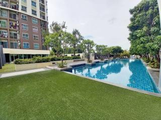 Residential building with outdoor pool and green lawn area