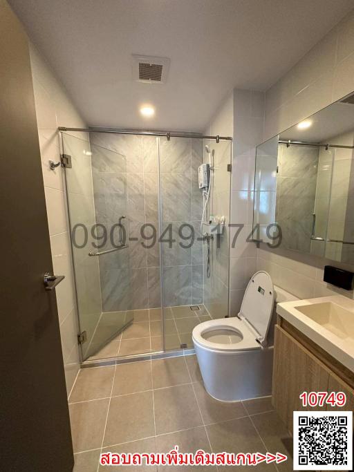Modern bathroom with glass shower and tiled walls