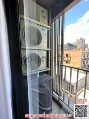 Balcony with air conditioning units and urban view