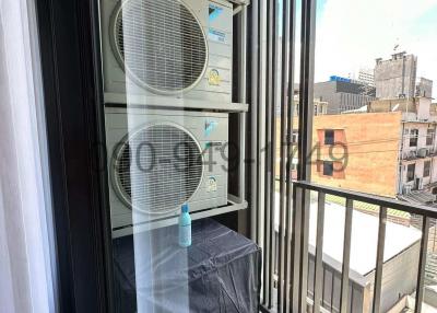 Balcony with air conditioning units and urban view