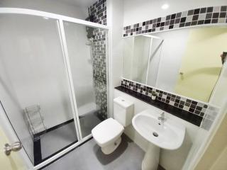 Modern bathroom with glass shower enclosure and tiled walls