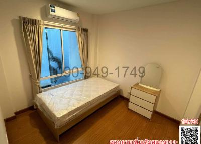 Cozy bedroom with natural light and air conditioning unit