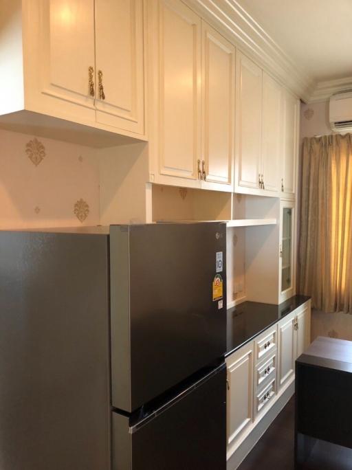 Modern kitchen with stainless steel appliances and white cabinetry