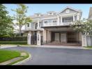 Elegant two-story house with paved driveway and landscaped front yard