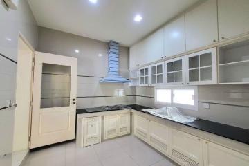 Modern kitchen with white cabinetry and stainless steel appliances