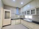 Modern kitchen with white cabinetry and stainless steel appliances