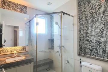 Modern bathroom with walk-in shower and mosaic tile detailing