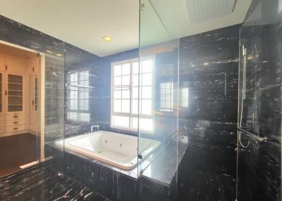 Modern bathroom with black marble finish and Jacuzzi tub