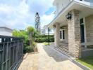 Elegant home exterior with stone cladding and paved pathway