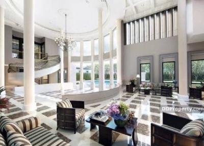 Elegant and spacious living room with high ceiling and luxurious decor