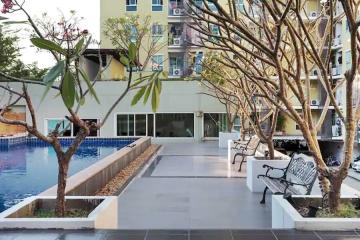 Residential building outdoor common area with pool and seating