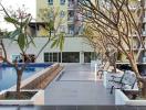 Residential building outdoor common area with pool and seating