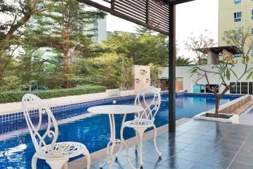 Outdoor pool area with seating and shade structure