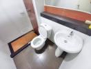 Clean modern bathroom with toilet and pedestal sink