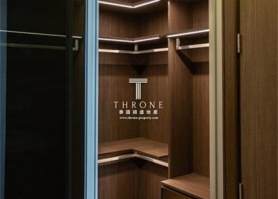Spacious walk-in closet with custom shelving and ambient lighting