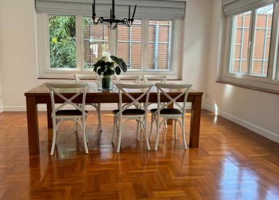 Spacious dining room with large windows and hardwood floors