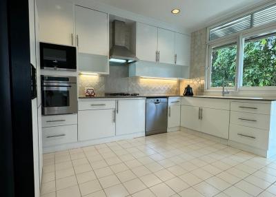 Modern kitchen with white cabinetry and stainless steel appliances