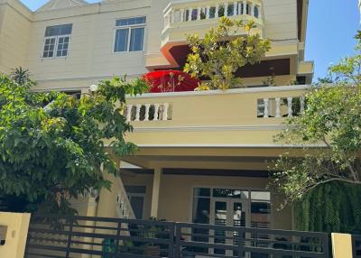 Modern multi-story residential building with balconies and gated entrance