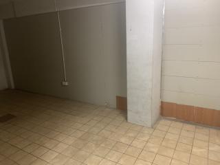 Empty interior space with tiled flooring and bare walls