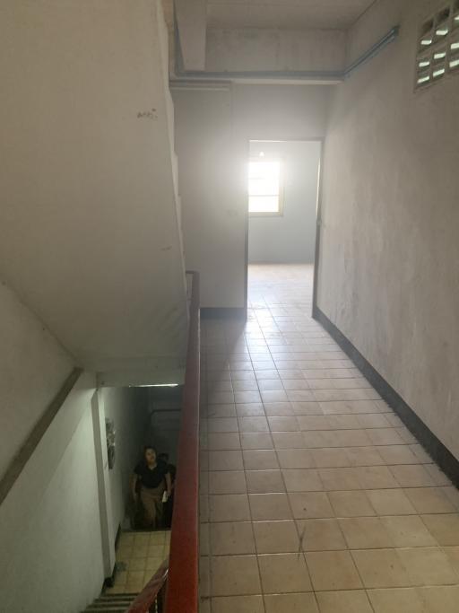 Interior staircase and hallway in a residential building with natural light