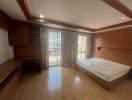 Spacious bedroom with large bed and wooden furnishings