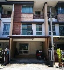 Modern townhouse exterior with carport