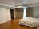 Spacious bedroom with hardwood floors and built-in wardrobe