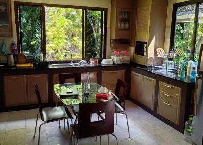Spacious kitchen with large windows and a dining area
