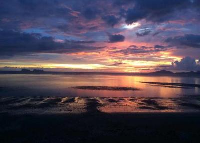 Beautiful sunset view over a calm beach with reflective water